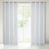 Two white curtains hanging in front of a window with greenery visible outside. Produktbild-Vorschau