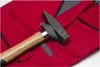 A close-up shot of a hammer resting on red workwear. Produktbild-Vorschau