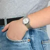 A person wearing a watch and jeans, with their hand in their pocket. Náhled obrázku produktu