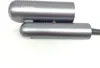 A close-up view of two gray cylindrical objects, likely parts of a hair dryer, against a white background. Podgląd zdjęcia produktu