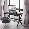 A gaming desk with a computer setup in a room with large windows and curtains. Produktbild-Vorschau
