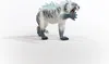 A toy tiger with ice-like spikes on its back, standing on a white surface. Produktbild-Vorschau