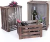 Three wooden crates are arranged on a white background. One crate contains two wine glasses and a bunch of grapes. Another crate holds a bottle of white wine and a small potted plant with lavender. The third crate contains a bottle of red wine. Náhled obrázku produktu
