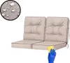 A set of beige cushions for a swing or bench, with a close-up inset showing water droplets on the fabric, and a hand in a blue glove cleaning the cushion with a yellow sponge. Náhľad obrázku produktu