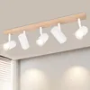 A ceiling light fixture with five adjustable spotlights mounted on a wooden beam, attached to a ceiling. Produktbild-Vorschau