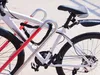 Close-up view of two bicycles locked to a bike rack. Produktbild-Vorschau