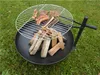 A grill grate with food cooking over a fire pit filled with wood. Produktbild-Vorschau