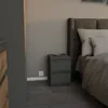 A bedroom scene with a nightstand next to a bed. Voir les images du produit