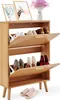 A wooden shoe cabinet with two flip-down drawers and a top shelf, displaying various shoes and decorative items. Podgląd zdjęcia produktu