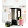 A soup maker with a glass of smoothie and a jar of jam on a kitchen counter. Produktbild-Vorschau