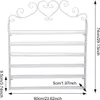 A white metal wall-mounted shelf with multiple tiers, featuring decorative scrollwork at the top. Dimensions are indicated with measurement lines and text. Podgląd zdjęcia produktu