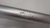 A close-up shot of a silver bicycle seatpost with some markings and a small blemish. Anteprima dell’immagine prodotto