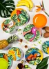 A collection of tropical-themed plates, fruits, and drinks arranged on a white surface. Anteprima dell’immagine prodotto