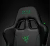 Close-up of a black gaming chair with green accents and branding. Podgląd zdjęcia produktu