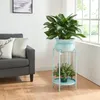 A living room scene with a sofa and a plant stand with plants. Voir les images du produit
