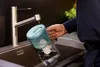 A person is filling a water filter pitcher under a faucet in a kitchen sink. Anteprima dell’immagine prodotto
