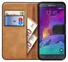 A book-style phone case with a Samsung Galaxy Note 4 inside, showing cards and euro banknotes. Náhled obrázku produktu