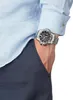 A man's wrist wearing a silver watch, with his hand in his pocket. Náhled obrázku produktu