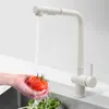 A hand washing a tomato and lettuce under a kitchen faucet. Náhled obrázku produktu