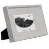 A white picture frame with a black and white photo inside, displayed on a white background. Produktbild-Vorschau
