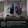 A modern laundry room or dressing area with clothes hanging on a rack and a washing machine graphic. Voir les images du produit