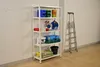 A white metal shelving unit filled with various storage containers, tools, and bags, standing against a white brick wall and a light gray wall. A silver ladder is positioned to the right of the shelving unit. Produktbild-Vorschau