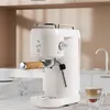 A white espresso machine is shown on a marble countertop with a cup of coffee in the foreground. Produktbild-Vorschau