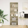 A tall, narrow bookshelf filled with books and storage boxes, placed next to a large potted plant and a desk with a laptop and lamp. Voir les images du produit