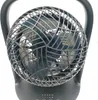 A black table fan with a spherical grille and a handle on top, set against a white background. Voir les images du produit