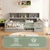 A child's bed with a built-in storage unit and a round rug in front of it. The bed is made of gray wood and has a green blanket and several pillows inside. There are toys and decorations on the shelves above the bed. A green overlay with text and icons is  Produktbild-Vorschau