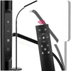 A black floor lamp with a remote control, shown in a studio setting with a white background. Náhled obrázku produktu