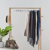 A wardrobe rack with pants and accessories. Produktbild-Vorschau