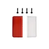A red and a clear plastic lens cover, along with four screws, are laid out on a white background. Produktbild-Vorschau