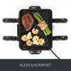 A top-down view of a small electric grill with food on it. Produktbild-Vorschau