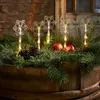 Christmas-themed decorative lights shaped like snowflakes are placed in a wooden planter filled with pine branches, pinecones, and red apples. Podgląd zdjęcia produktu