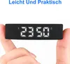 A hand holding a black fitness tracker with a digital display showing the time. Produktbild-Vorschau