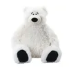 A white polar bear stuffed animal is sitting on a white background. Voir les images du produit