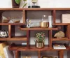 A wooden shelf unit displaying various decorative items. Voir les images du produit