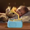 A baby sleeping next to a teddy bear with a toy gramophone playing music. Náhľad obrázku produktu