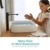 A young girl is washing her hands at a modern bathroom sink. Voir les images du produit
