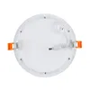 The back of a round, flat LED recessed light fixture with orange spring clips and a white power cable. Produktbild-Vorschau