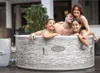 A family enjoying a hot tub outdoors. Produktbild-Vorschau