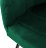 A close-up view of a dark green velvet chair seat and armrest. Náhľad obrázku produktu