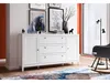 A white dresser with drawers and a cabinet is shown in a room with artwork on the wall and a rocking chair nearby. Náhľad obrázku produktu