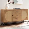 A wooden sideboard with cane detailing and black metal legs, displayed in a room setting. Produktbild-Vorschau