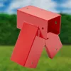 A red metal swing set connector is shown against a blurred background of green grass and a blue sky. Produktbild-Vorschau