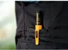 A close-up of a black work pant pocket with a yellow and black marker clipped to it. Produktbild-Vorschau