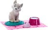 A toy wolf puppy with a food bowl and brush on a pink mat. Produktbild-Vorschau