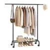A clothing rack with clothes and shoes on display, with a handbag and hat as accessories. Produktbild-Vorschau