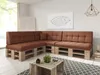 A modern living room with a sectional sofa made of wooden pallets and brown cushions, a coffee table made of wooden crates, and a geometric pendant light. Produktbild-Vorschau